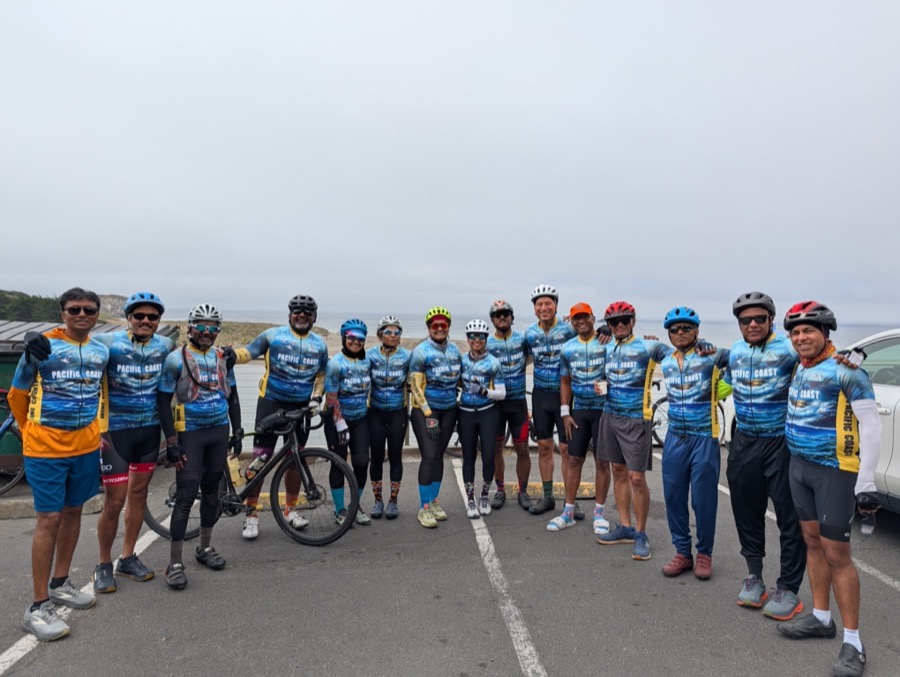 A Saval cycling group in matching Pacific Coast jerseys posed along the California coastline